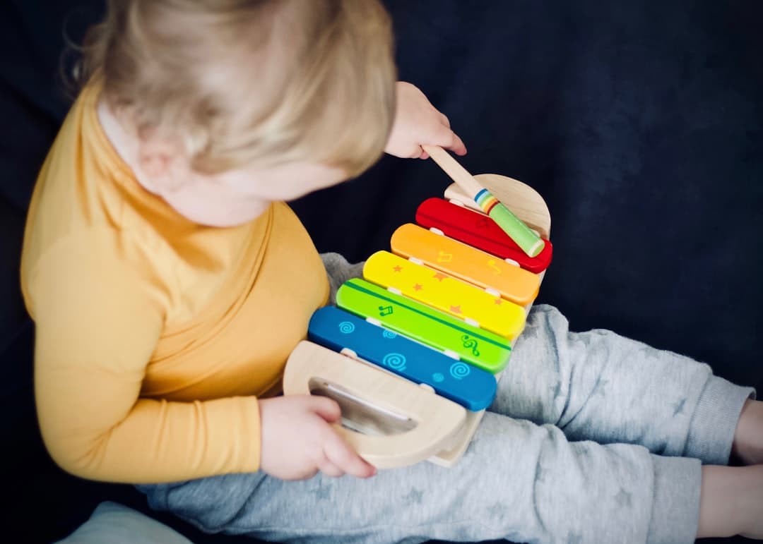 Child with a rainbow xylophone